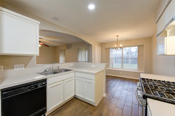 a kitchen with a sink stove and cabinets