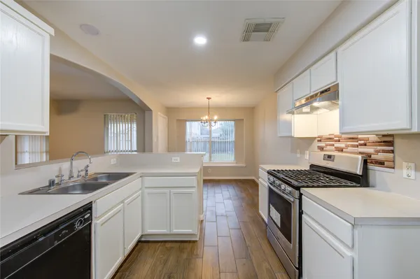 a kitchen that has a sink and a stove in it