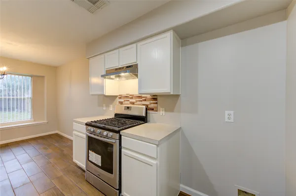 a kitchen with a stove cabinets and a sink