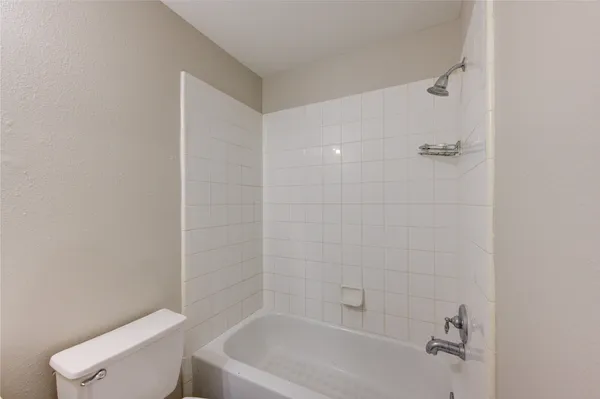 a bathroom with a toilet and bathtub