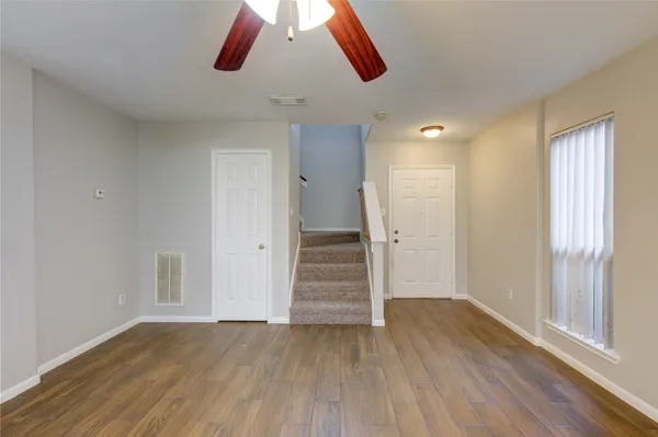 wooden floor in an empty room with a window