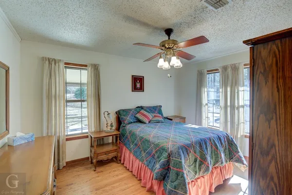 a view of a bedroom with closet and wooden floor