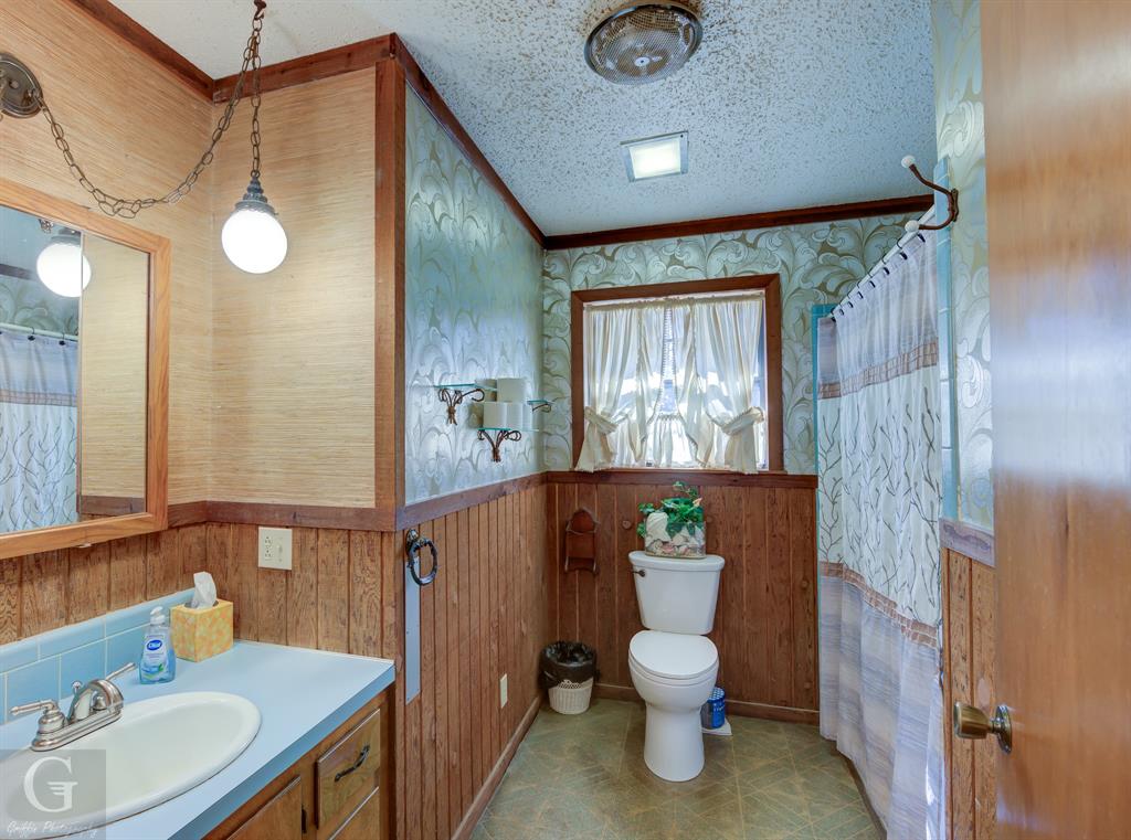 7105 Rodessa Ida Road Ida, LA 71044 - Photo 17 of 40 a bathroom with a toilet a sink and a mirror