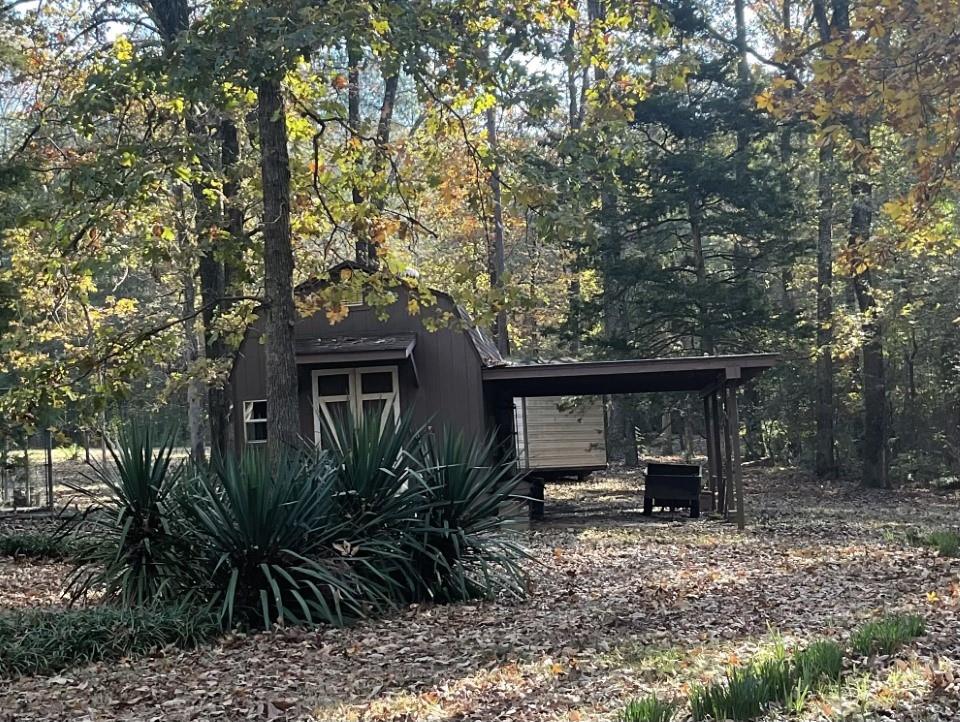 7105 Rodessa Ida Road Ida, LA 71044 - Photo 22 of 40 a front view of a house with garden and sitting area