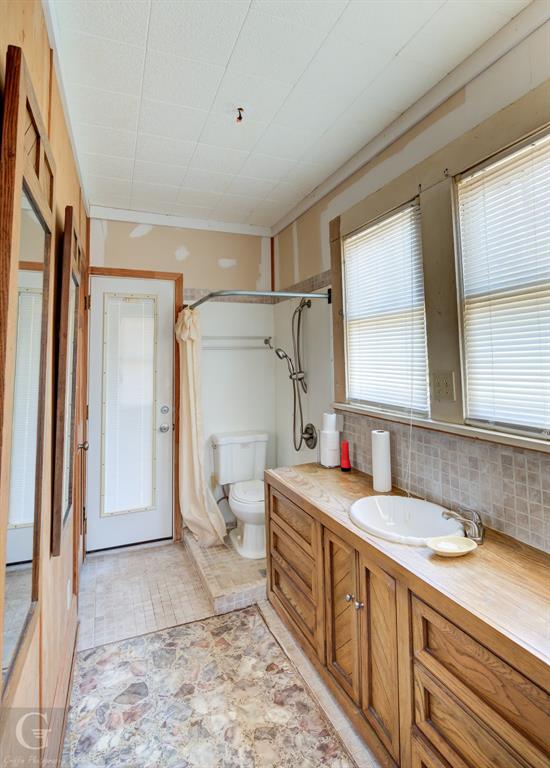 7105 Rodessa Ida Road Ida, LA 71044 - Photo 32 of 40 a bathroom with a granite countertop sink mirror vanity and toilet