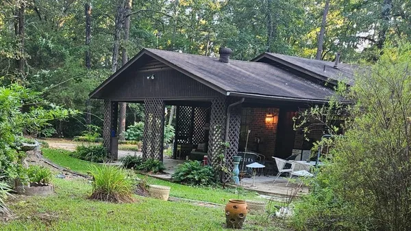a kitchen filled with stainless steel appliances granite countertop a sink dishwasher a refrigerator and cabinets with wooden floor