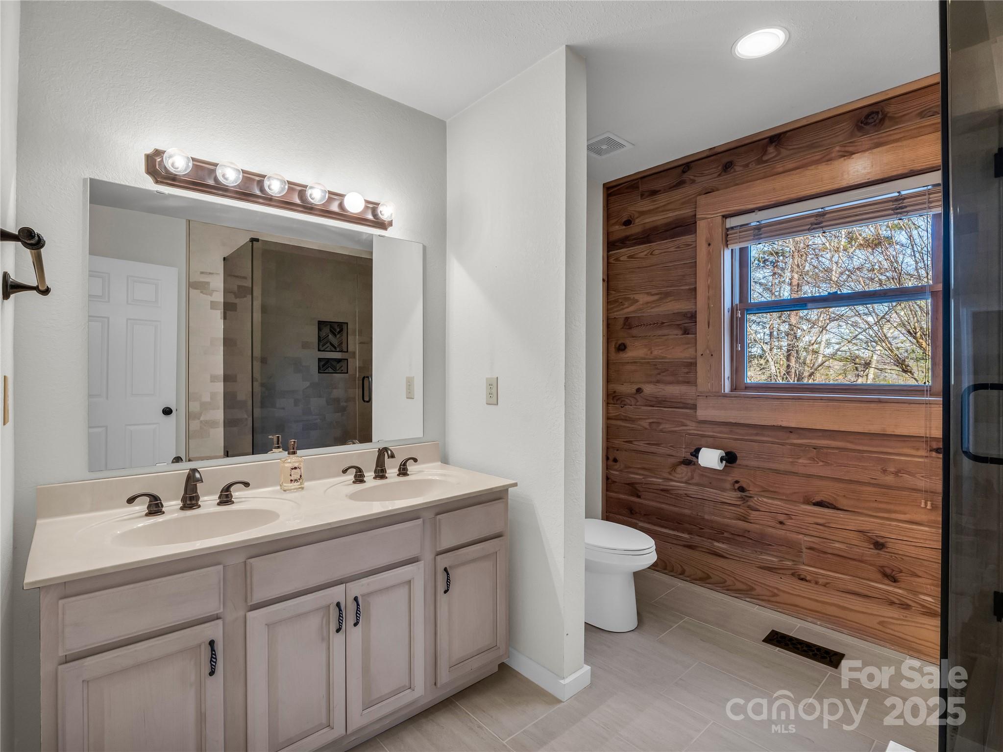 134 Raleigh Drive Lake Lure, NC 28746 - Photo 22 of 45 a bathroom with a double vanity sink mirror and toilet