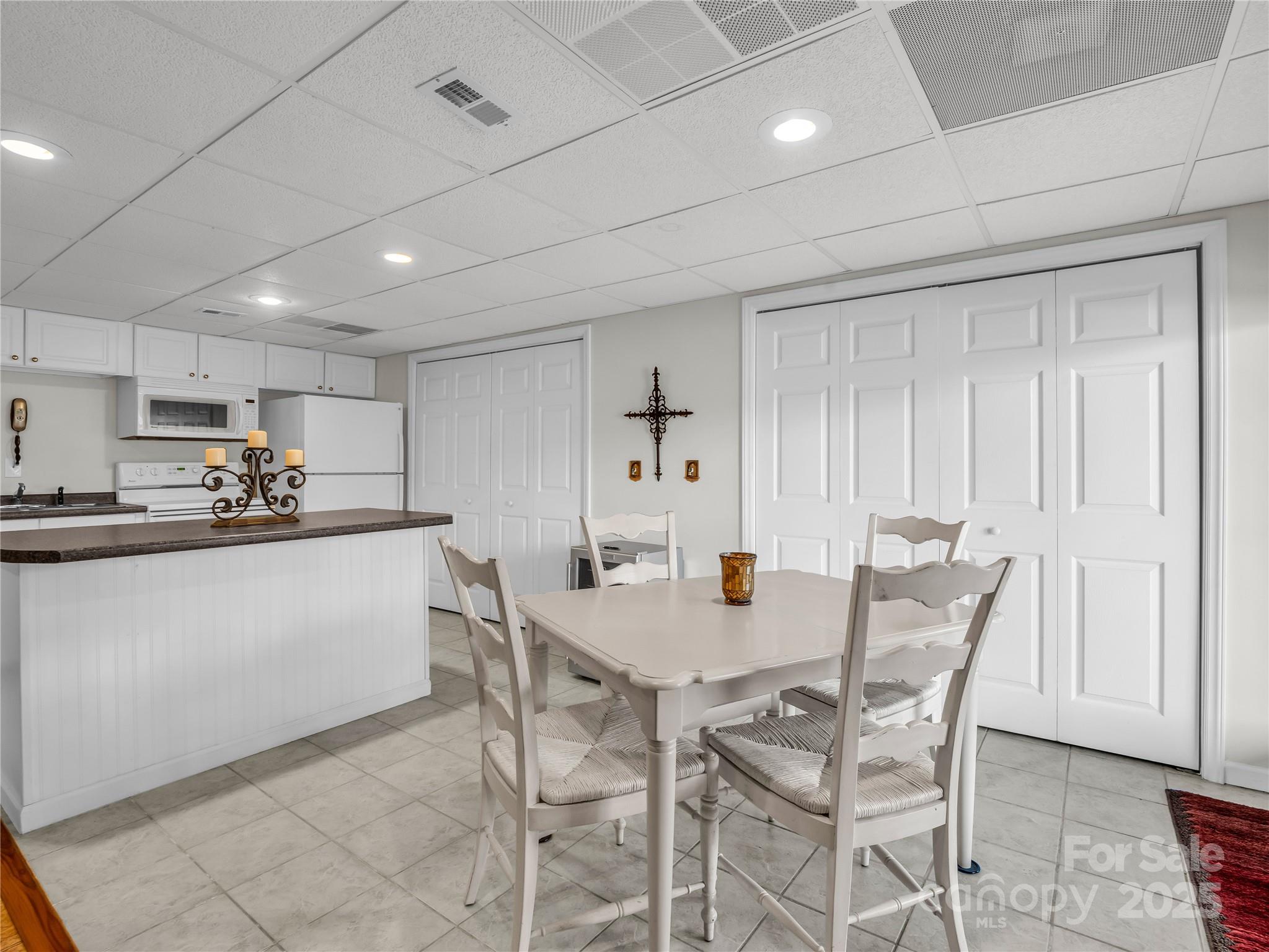 134 Raleigh Drive Lake Lure, NC 28746 - Photo 33 of 45 a kitchen with a table chairs refrigerator and cabinets