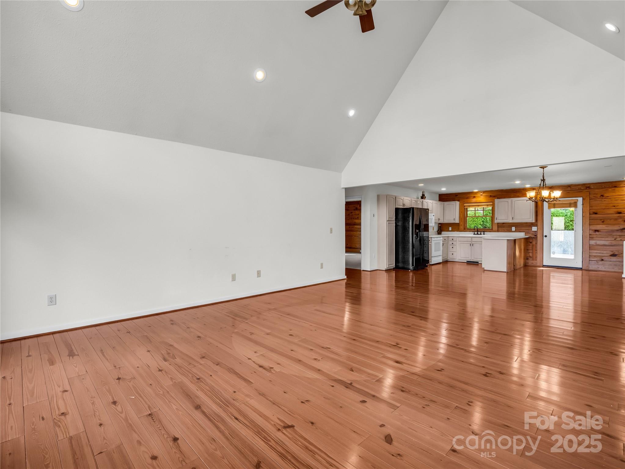 134 Raleigh Drive Lake Lure, NC 28746 - Photo 5 of 45 an empty room with wooden floor and windows