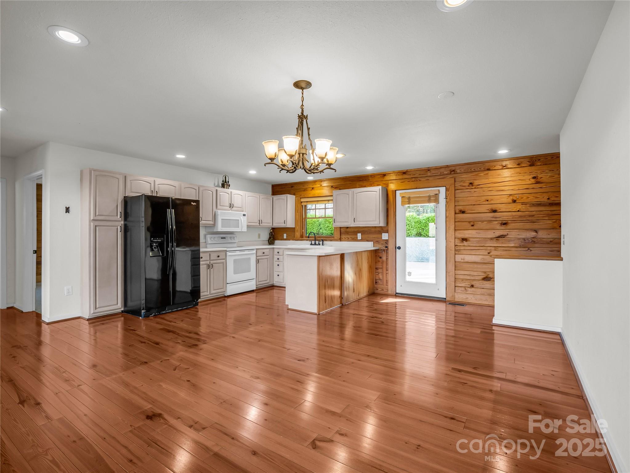 134 Raleigh Drive Lake Lure, NC 28746 - Photo 6 of 45 a view of a kitchen with granite countertop stainless steel appliances and wooden floor