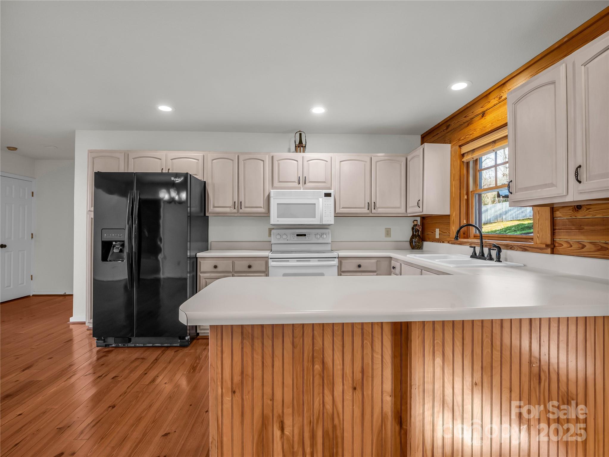 134 Raleigh Drive Lake Lure, NC 28746 - Photo 8 of 45 a kitchen with stainless steel appliances granite countertop a refrigerator a sink dishwasher and a stove with wooden floor