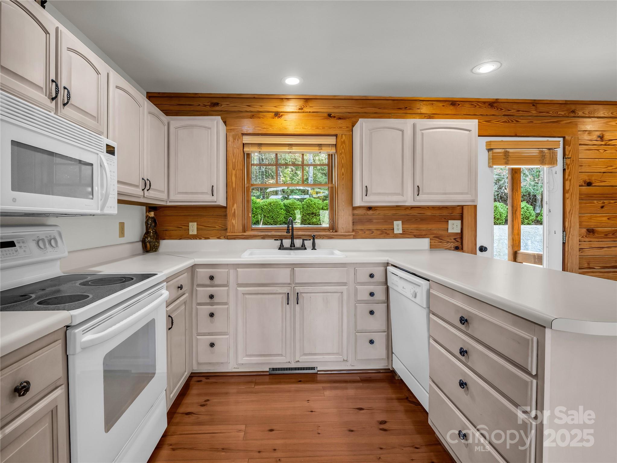 134 Raleigh Drive Lake Lure, NC 28746 - Photo 9 of 45 a kitchen with cabinets appliances a sink and a window