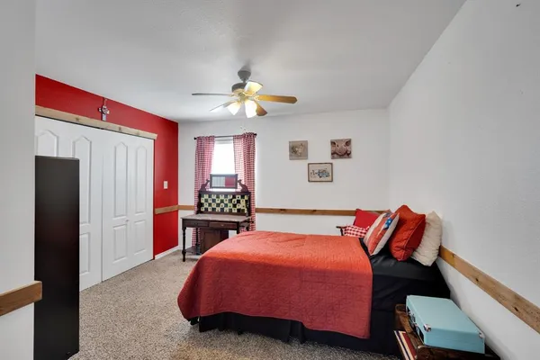 a bedroom with a bed and window