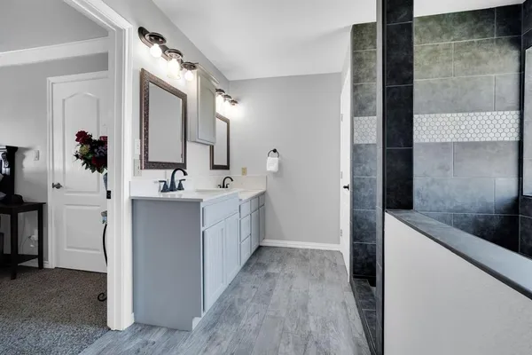a bathroom with a bathtub and a shower