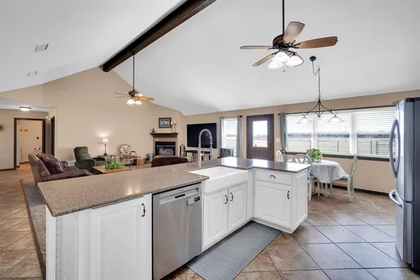 a kitchen with granite countertop a sink stainless steel appliances and cabinets