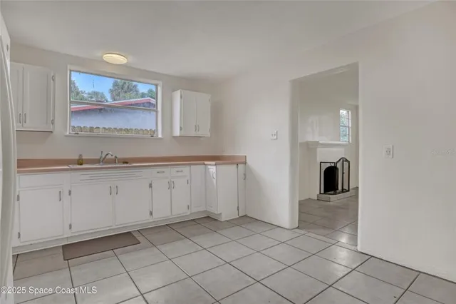 a kitchen with cabinets a refrigerator and a stove