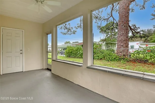 a view of room with window and ceiling fan