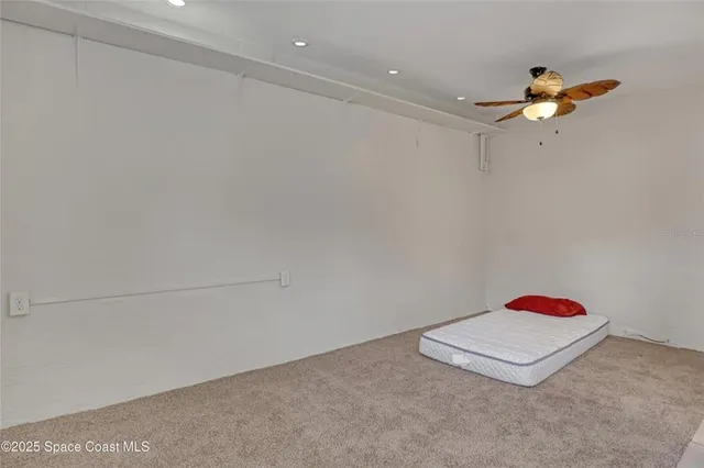 an empty room with windows and cabinet