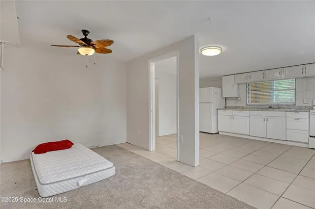 a bathroom with a toilet a sink a mirror and a window