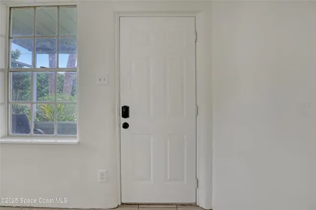 a view of a livingroom with a fireplace and a chandelier fan