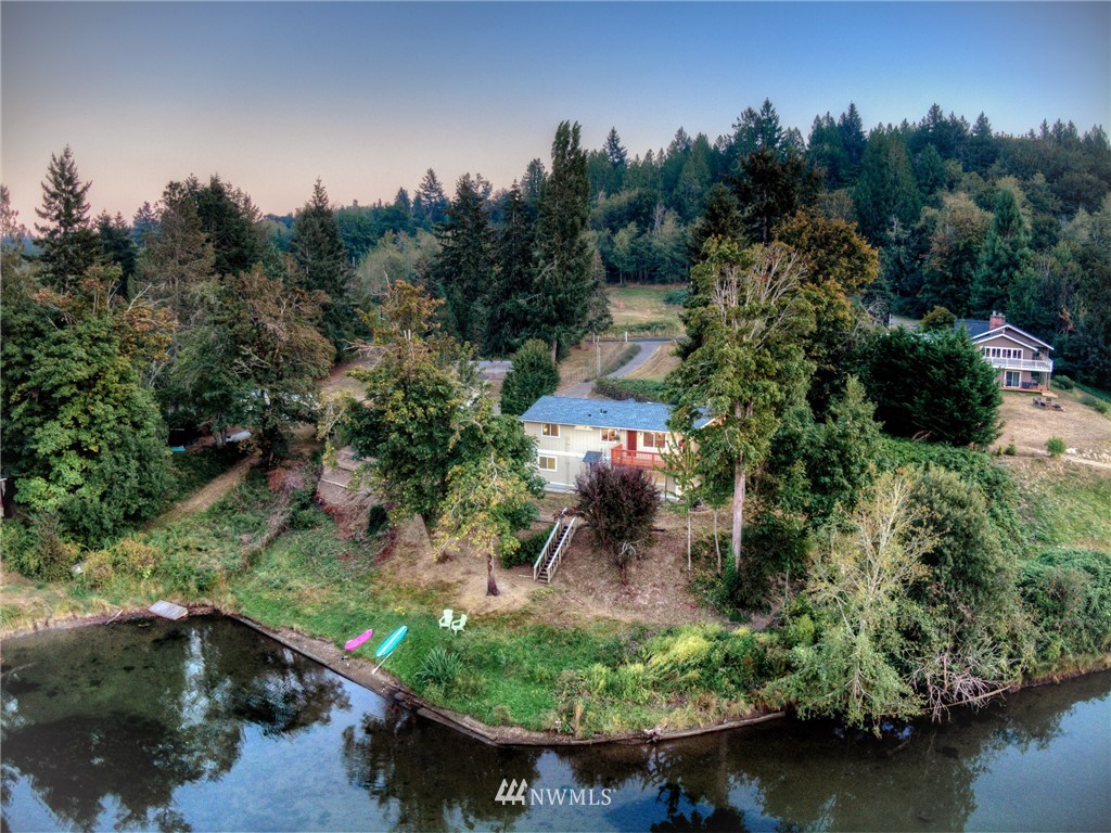 19605 Whiteman Cove Road Southwest Lakebay, WA 98351 - Photo 1 of 40 an aerial view of a house with a yard lake and outdoor seating