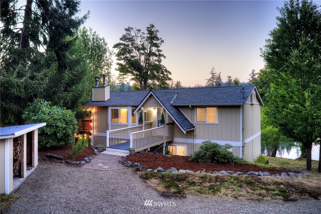 19605 Whiteman Cove Road Southwest Lakebay, WA 98351 - Photo 2 of 40 a front view of a house with a garden