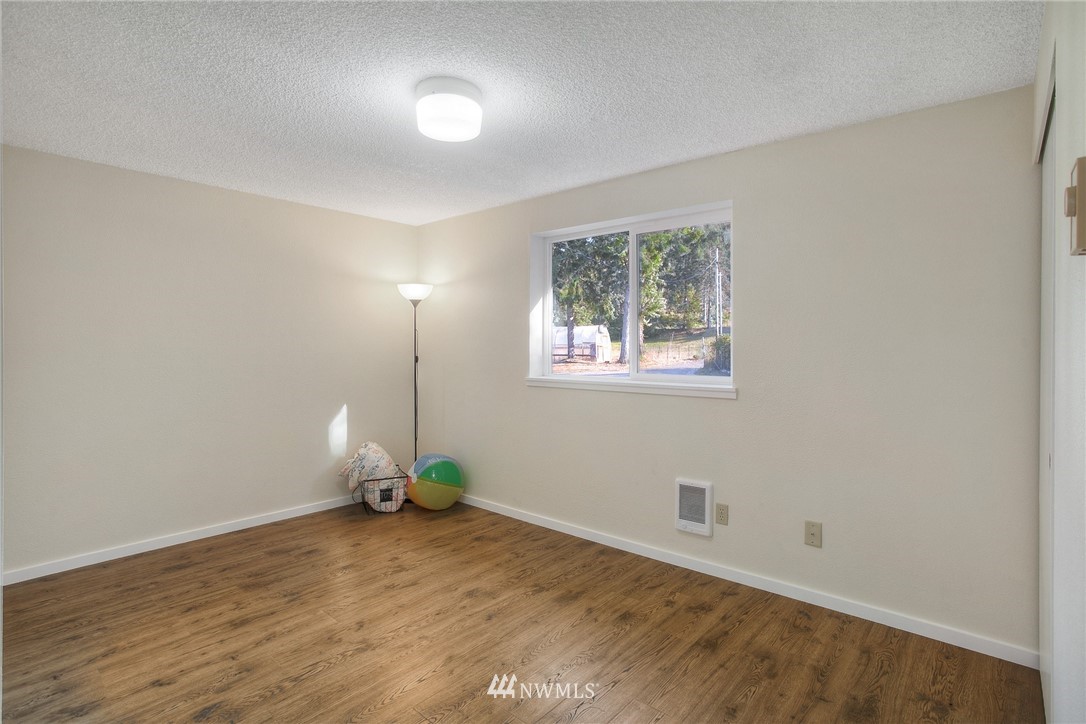 19605 Whiteman Cove Road Southwest Lakebay, WA 98351 - Photo 11 of 40 a view of empty room with wooden floor