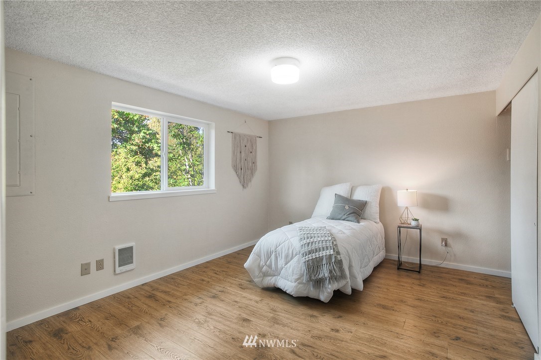19605 Whiteman Cove Road Southwest Lakebay, WA 98351 - Photo 12 of 40 a bedroom with a bed and a window