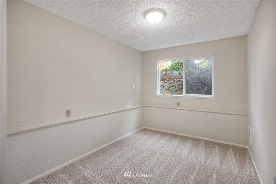 19605 Whiteman Cove Road Southwest Lakebay, WA 98351 - Photo 22 of 40 an empty room with a window