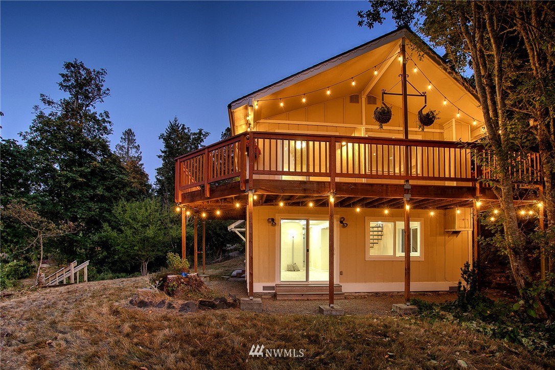 19605 Whiteman Cove Road Southwest Lakebay, WA 98351 - Photo 4 of 40 a view of a house with a yard