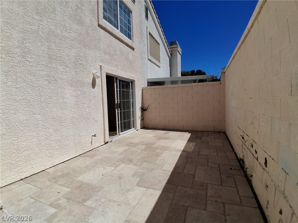 8023 Simone Avenue Las Vegas, NV 89147 - Photo 12 of 12 A private, tiled patio extends from the home, perfect for outdoor relaxation.