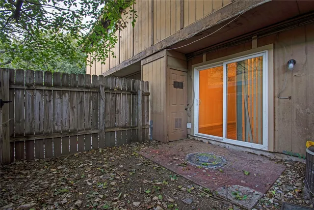 a view of a house with wooden fence