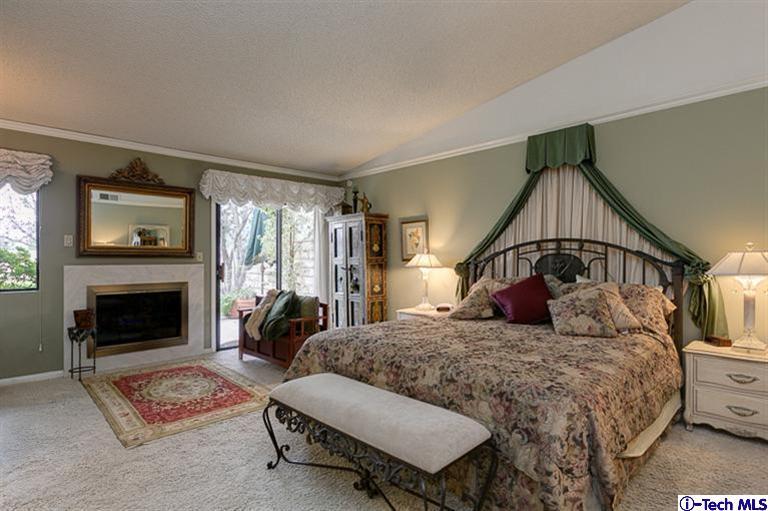 2031 Rosemont Avenue, Unit 2 Pasadena, CA 91103 - Photo 18 of 33 a bedroom with a bed and a fireplace