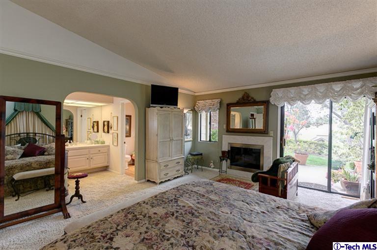2031 Rosemont Avenue, Unit 2 Pasadena, CA 91103 - Photo 19 of 33 a bedroom with furniture a fireplace and a floor to ceiling window