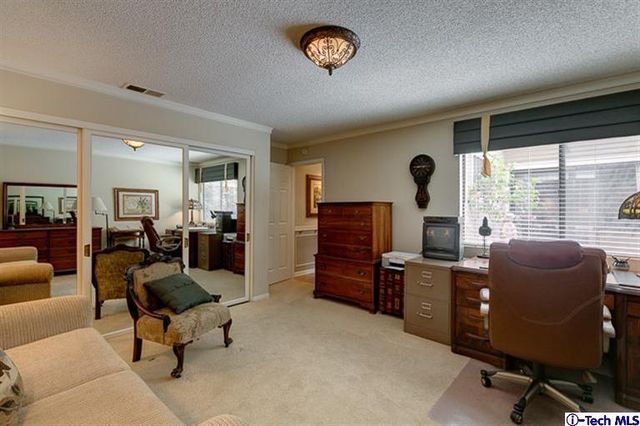 a livingroom with workspace and a window