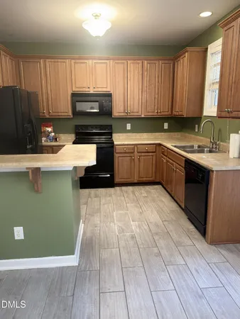 a kitchen with a sink a stove and cabinets