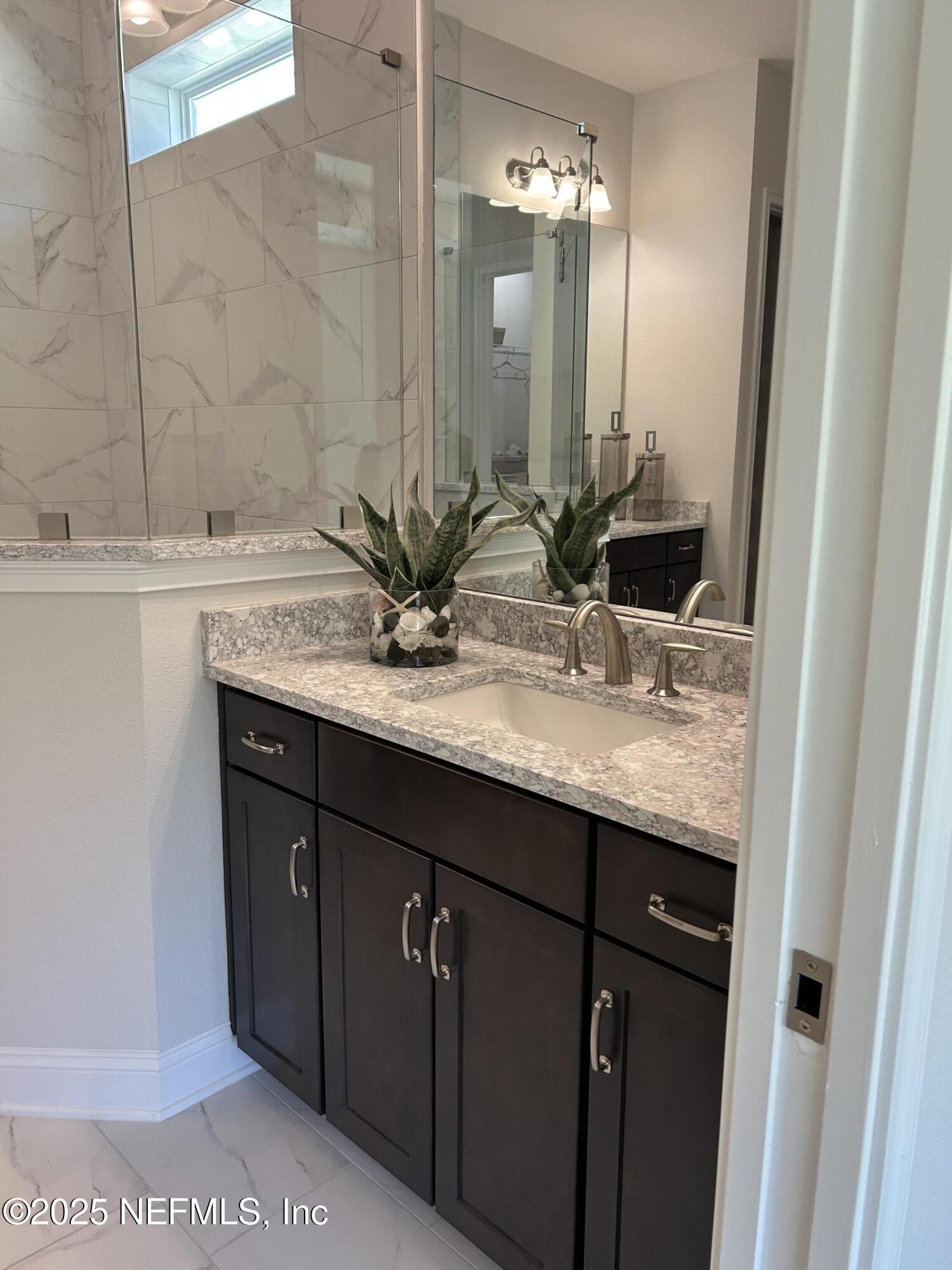 486 Navigators Road St. Johns, FL 32259 - Photo 15 of 22 a bathroom with a granite countertop sink and a mirror
