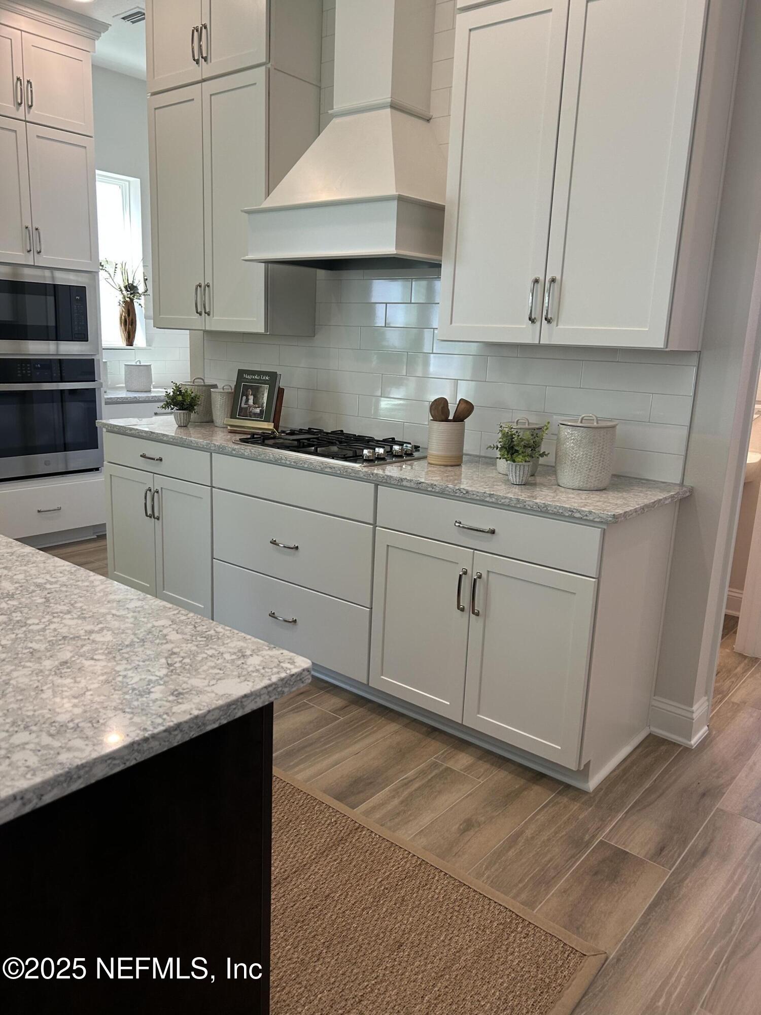 486 Navigators Road St. Johns, FL 32259 - Photo 8 of 22 a kitchen with stainless steel appliances granite countertop a sink and cabinets