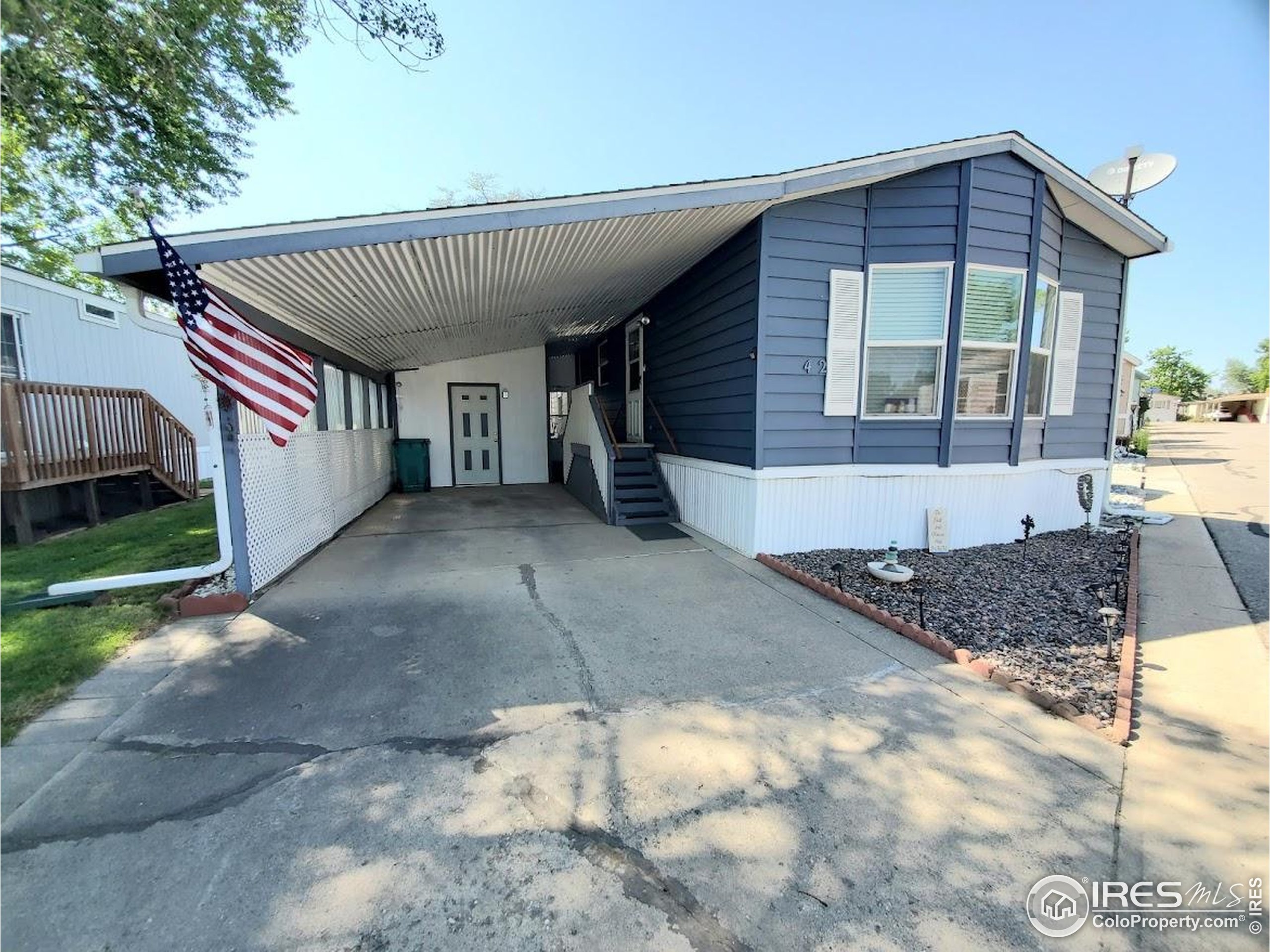 605 West 57th Street, Unit 42 Loveland, CO 80538 - Photo 1 of 38 a front view of a house with a yard