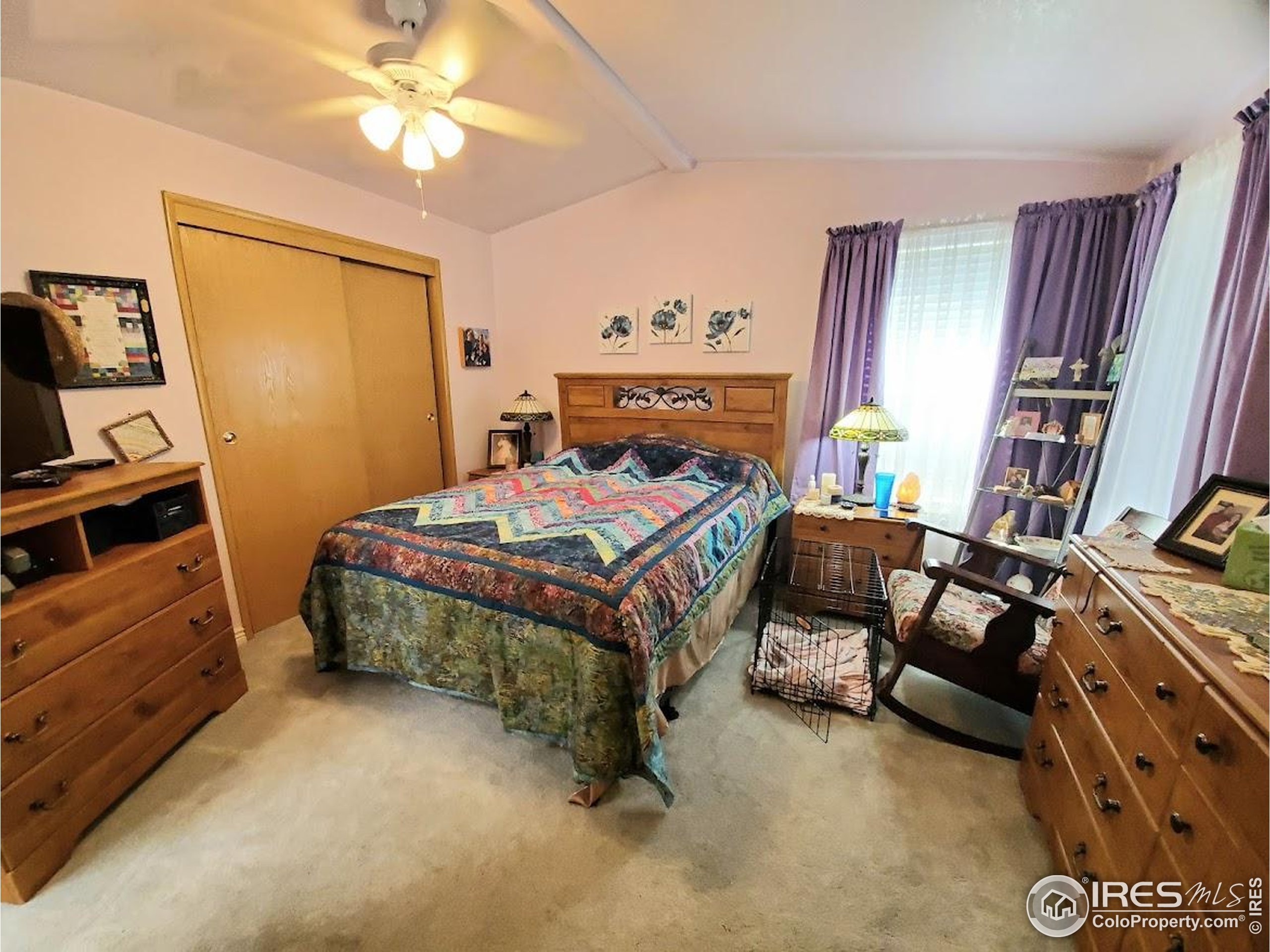 605 West 57th Street, Unit 42 Loveland, CO 80538 - Photo 12 of 38 a bedroom with a bed and a chandelier