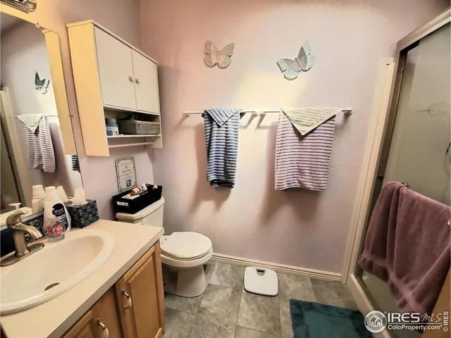 a bathroom with a sink toilet and mirror