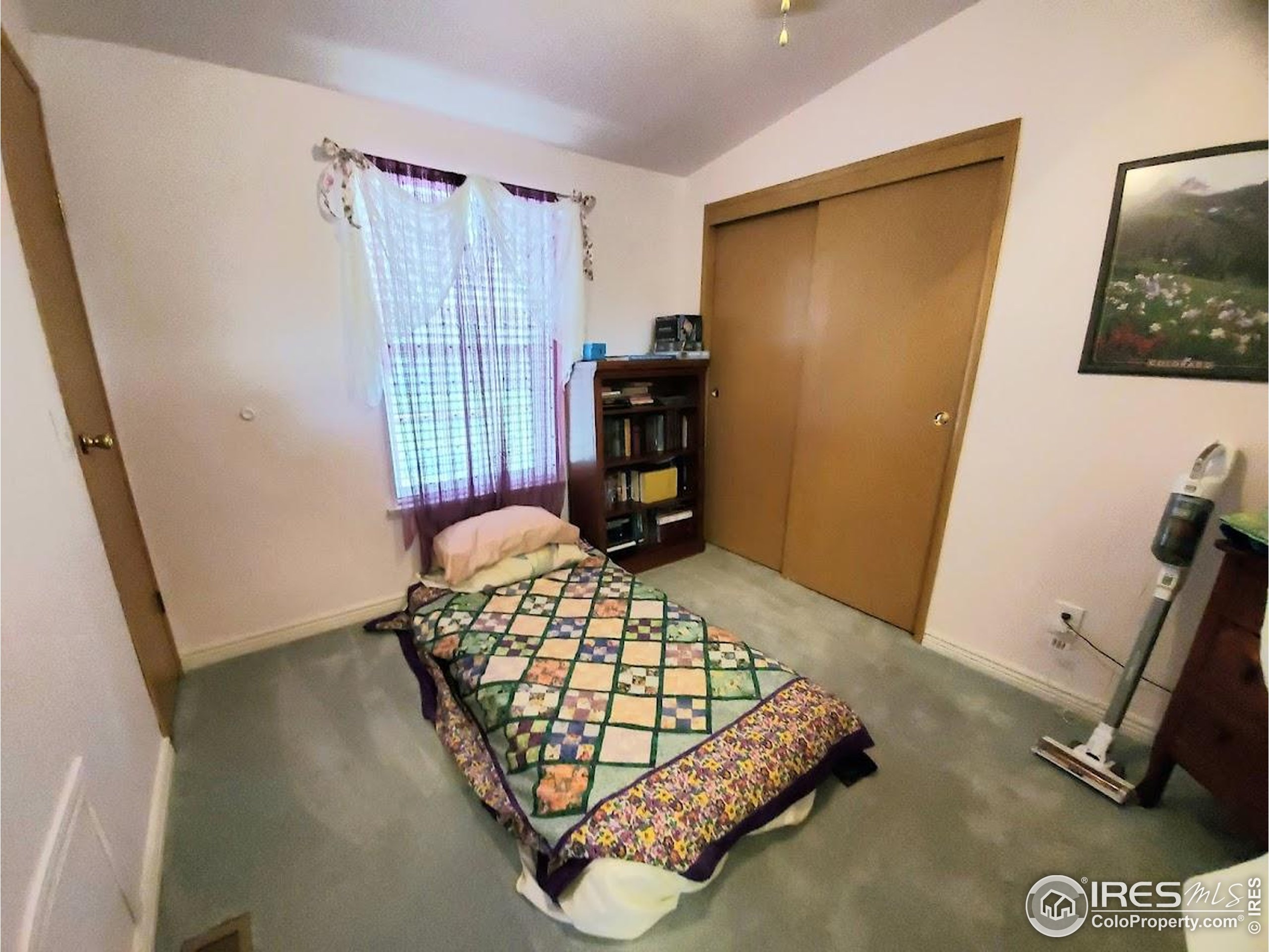 605 West 57th Street, Unit 42 Loveland, CO 80538 - Photo 18 of 38 a bedroom with a bed and wooden floor