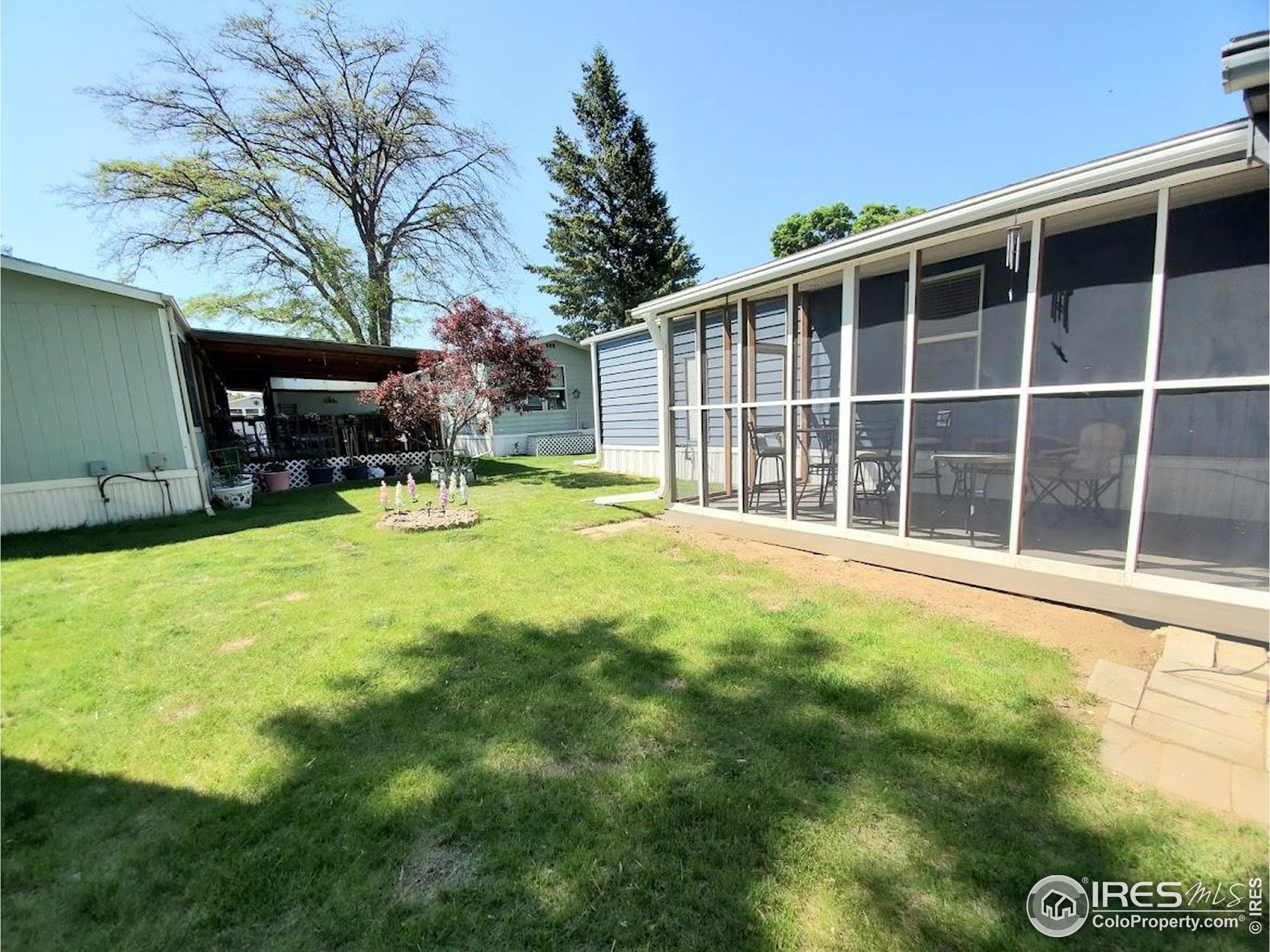 605 West 57th Street, Unit 42 Loveland, CO 80538 - Photo 27 of 38 a view of a house with backyard and sitting area