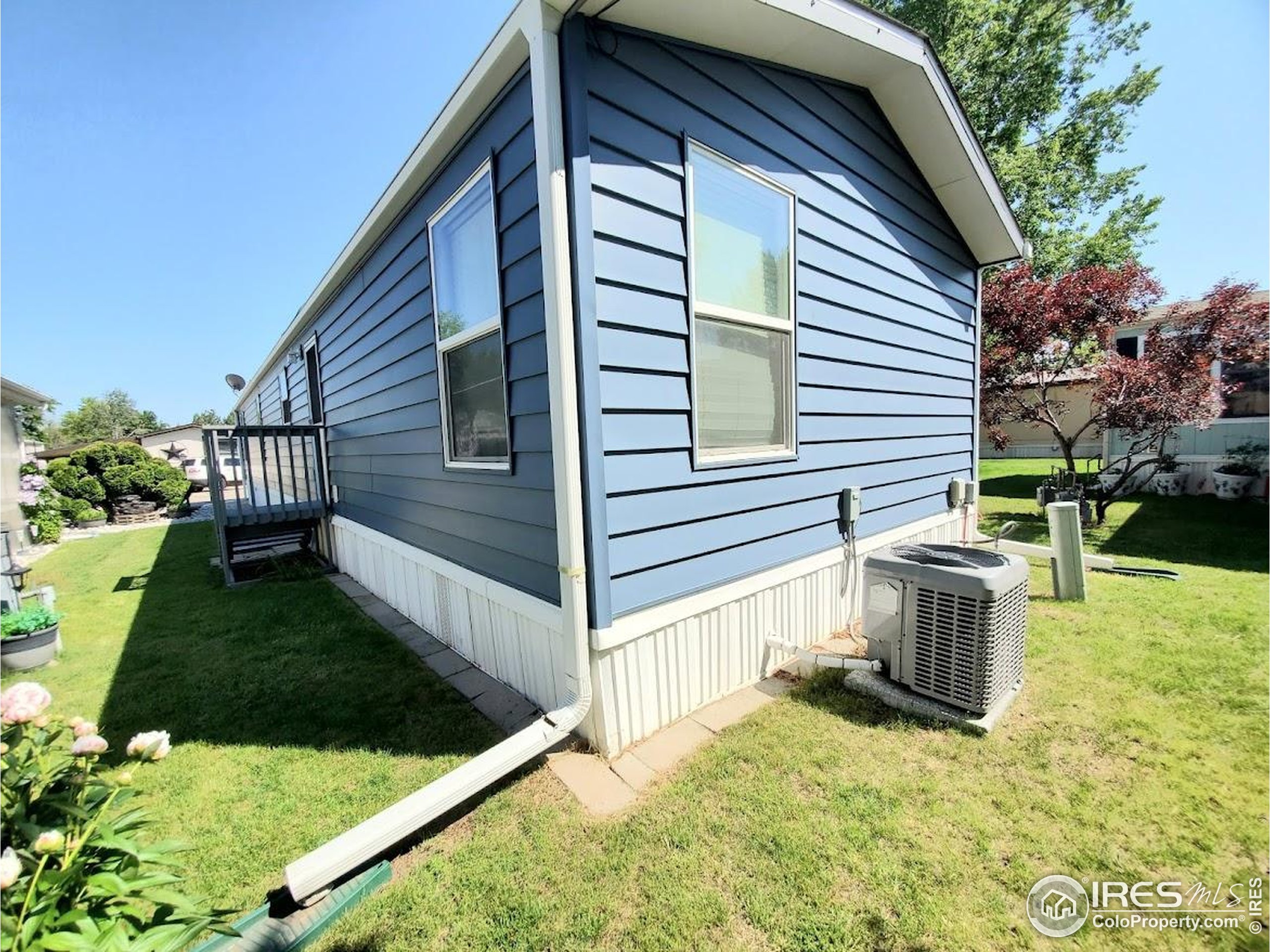 605 West 57th Street, Unit 42 Loveland, CO 80538 - Photo 31 of 38 a view of a house with backyard and sitting area