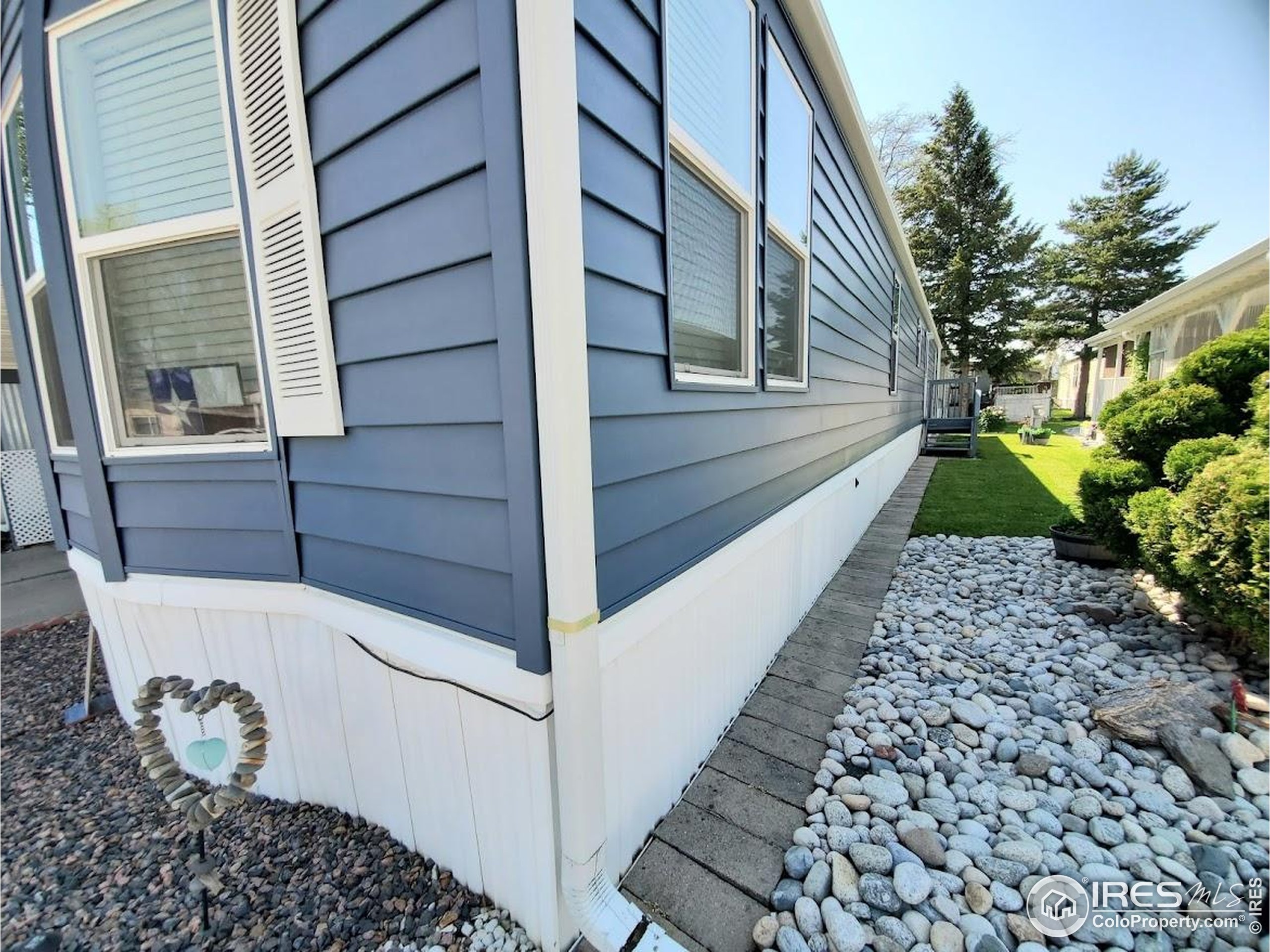 605 West 57th Street, Unit 42 Loveland, CO 80538 - Photo 32 of 38 a house with a outdoor space