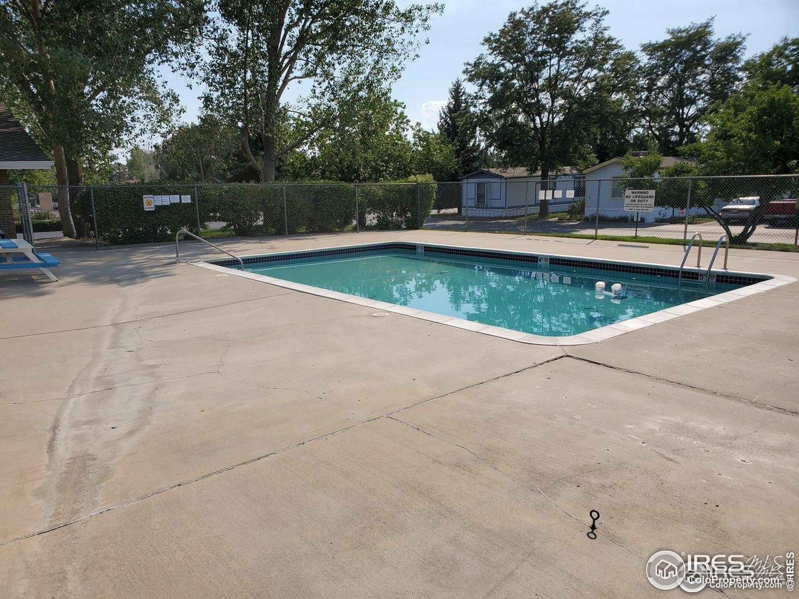 605 West 57th Street, Unit 42 Loveland, CO 80538 - Photo 33 of 38 a view of a swimming pool with a patio