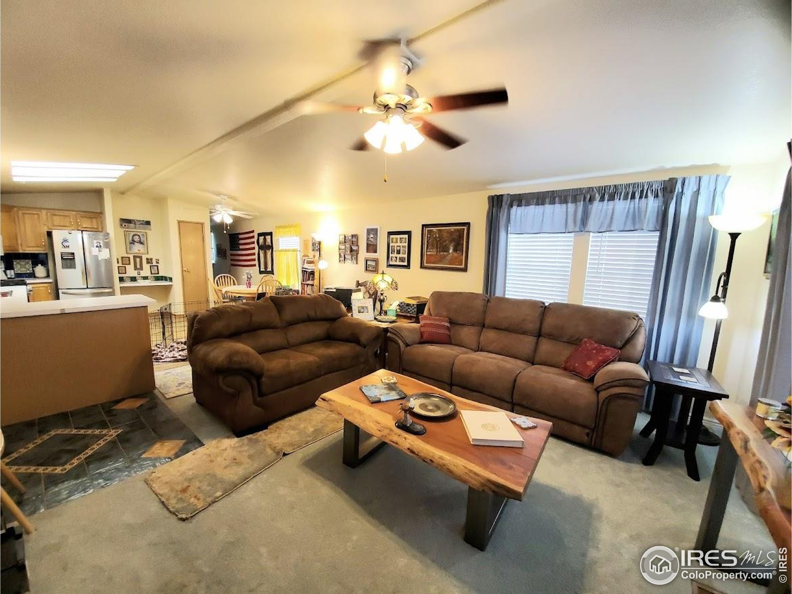 605 West 57th Street, Unit 42 Loveland, CO 80538 - Photo 4 of 38 a living room with furniture and a chandelier