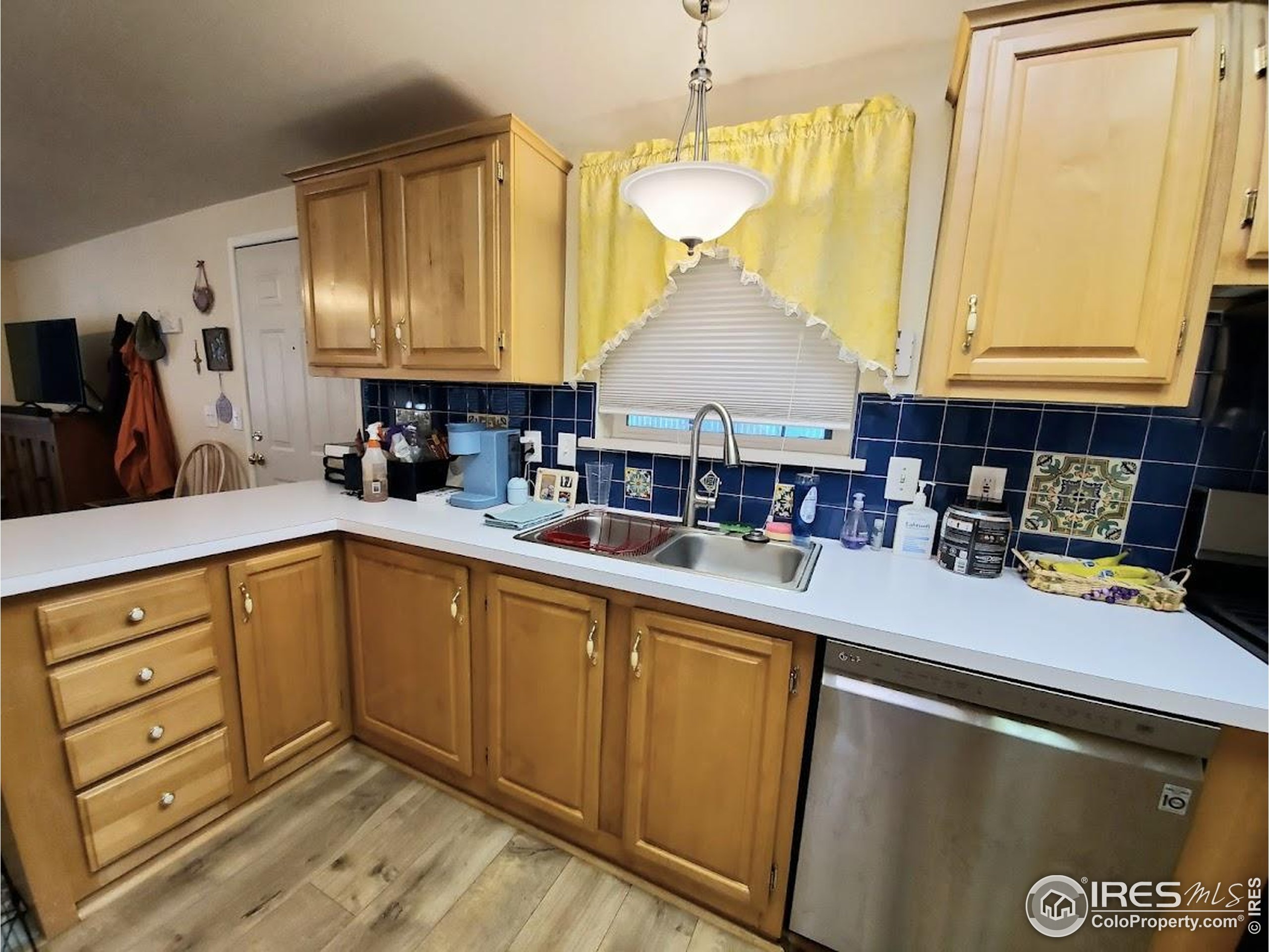 605 West 57th Street, Unit 42 Loveland, CO 80538 - Photo 8 of 38 a kitchen with a sink appliances and cabinets