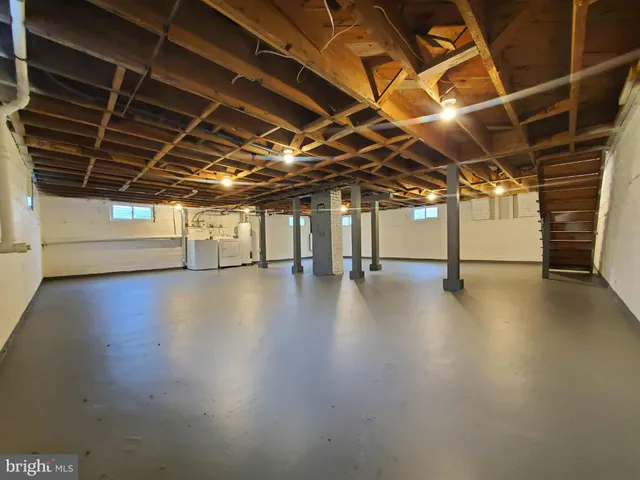 a view of a room with wooden floors