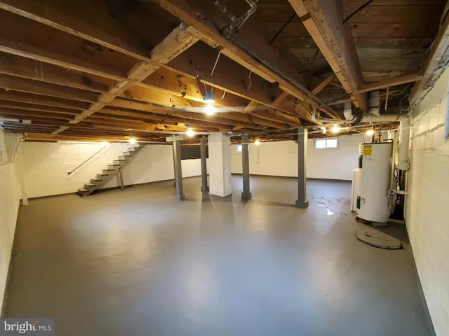 a view of empty room with wooden floors